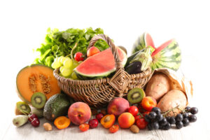summer assorted of fruit and vegetable composition in wicker basket